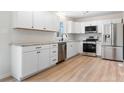 Modern white kitchen featuring stainless steel appliances and sleek countertops at 4065 Lost Creek Ct, Hickory, NC 28602