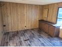 Cozy room with wood-paneled walls, base cabinets, and durable flooring at 4161 Slanting Bridge Rd, Sherrills Ford, NC 28673