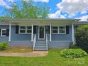 Close-up of home's entrance, highlighting the covered porch and inviting curb appeal at 4930 Crestmont Dr, Charlotte, NC 28205