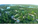 Aerial view of a neighborhood by the lake, with lush green trees and beautiful homes at 6108 Gold Creek Estate Dr, Hickory, NC 28601