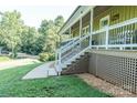 View of the house with a inviting front porch and well-manicured lawn at 6108 Gold Creek Estate Dr, Hickory, NC 28601