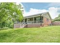 A charming home with a covered front porch and a well-maintained yard at 6108 Gold Creek Estate Dr, Hickory, NC 28601