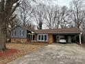 Charming single-story home with a brick and siding facade, complimented by a covered carport for convenient parking at 818 W 6Th St, Newton, NC 28658