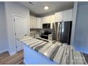 Modern kitchen featuring sleek stainless steel appliances and a stylish marble countertop at 916 Moose St, Lowell, NC 28098