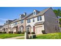Charming two-story townhomes with attached garages, manicured lawns, and inviting curb appeal at 9760 Springholm Dr, Charlotte, NC 28278