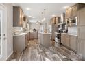 Spacious kitchen with modern appliances, central island, and stylish wood-look flooring at 1005 Maywood St, Kannapolis, NC 28081