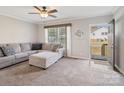 Cozy living room with plush sectional couch, ceiling fan, and a view of the outdoors at 1005 Maywood St, Kannapolis, NC 28081