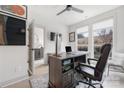 Bright home office with modern desk, ceiling fan, and large windows at 1108 Wesley Terrace Ave, Charlotte, NC 28208
