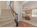 Inviting foyer with carpeted stairs and hardwood floors leading to a sunlit living area at 1245 Periwinkle Dr, Waxhaw, NC 28173