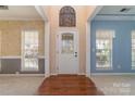Elegant foyer featuring a decorative glass front door and wood flooring at 1245 Periwinkle Dr, Waxhaw, NC 28173