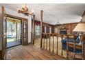 Cozy living room showcasing a brick fireplace, wood paneling, and unique lighting at 126 Lynnwood Ln, Pineville, NC 28134