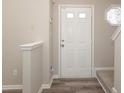 Bright entryway featuring a white front door, hardwood floors and decorative stained glass window at 14713 Lions Pride Ct, Charlotte, NC 28273