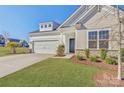 Charming home featuring a two-car garage, rock accents, and lush landscaping at 19007 Dry Narrows Way, Charlotte, NC 28278
