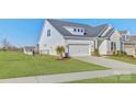 A lovely single-Gathering home boasts a well-maintained lawn and white garage, perfect for suburban living at 19007 Dry Narrows Way, Charlotte, NC 28278