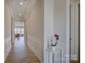 Inviting hallway with white wainscoting and wood floors leading to the living area at 19007 Dry Narrows Way, Charlotte, NC 28278