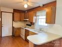 Efficient kitchen with a breakfast bar, double sink, wood cabinets and laminate countertops at 219 W Edison Dr, Statesville, NC 28625