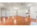 Spacious living room featuring hardwood floors, bright lighting, and structural columns at 2323 Pinefield Ct, Gastonia, NC 28056