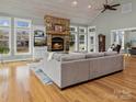 Cozy living room showcases a stone fireplace, built-in shelving, and hardwood floors at 246 Apache Rd, Troutman, NC 28166