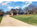 Beautiful brick home featuring a well-maintained lawn and a long driveway at 286 Canvasback Rd, Mooresville, NC 28117