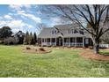 Beautiful brick home featuring a well-maintained lawn and inviting front porch at 286 Canvasback Rd, Mooresville, NC 28117