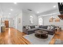 Spacious living room with hardwood floors, a sectional sofa, and an open floor plan for seamless entertaining at 4008 Saint Andrews Ct, Cramerton, NC 28032