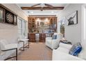 Entertaining space featuring a bar with custom cabinetry, mini-fridge, stone backsplash, and comfortable seating at 4008 Saint Andrews Ct, Cramerton, NC 28032