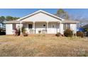 Charming one story home featuring a cozy front porch with benches and well-maintained landscaping on a spacious lot at 431 Island Cove Rd # 86, Norwood, NC 28128