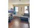 View of the living room with hardwood floors, sofa, TV, and windows at 642 E Black St, Rock Hill, SC 29730