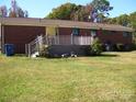 Back of the house with a wooden deck, perfect for enjoying outdoor living and the expansive backyard at 6434 Miller Rd, Kannapolis, NC 28081