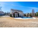 Stunning backyard with a spacious pool, screened porch, and well-maintained lawn, perfect for outdoor relaxation and entertainment at 8471 Penton Pl, Harrisburg, NC 28075