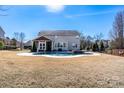 Enjoy a private backyard oasis with a sparkling pool, perfect for relaxing and entertaining guests in style at 8471 Penton Pl, Harrisburg, NC 28075