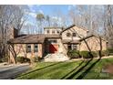Charming home with a brick exterior, complemented by manicured landscaping and mature trees at 1006 Lost Cv, Weddington, NC 28104