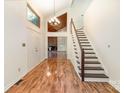 Bright foyer featuring hardwood floors, staircase, and access to the living spaces at 1006 Lost Cv, Weddington, NC 28104
