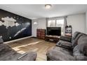 Comfortable living room featuring a dark accent wall, plush seating, and wood-look herringbone floors at 108 S Inman Ave, Bessemer City, NC 28016