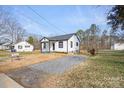 Well-maintained home with a gravel driveway and a cozy covered front porch at 1110 Alexander St, Statesville, NC 28677