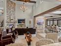 Bright living room with a stone fireplace, hardwood floors, and floor-to-ceiling windows providing ample natural light at 1238 Ladera Dr, Waxhaw, NC 28173