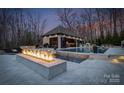Gorgeous pool and outdoor bar area with a luxurious fire pit and comfortable seating at 1238 Ladera Dr, Waxhaw, NC 28173