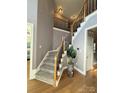 Elegant two-story entryway with staircase, featuring hardwood floors and modern decor at 12504 Ivey Creek Dr, Charlotte, NC 28273