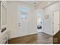 Bright foyer featuring wood flooring, white walls, and a view of a bedroom at 1332 Augustus Beamon Dr, Indian Trail, NC 28079