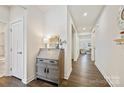 Hallway featuring wood flooring, white walls, and an accent table with decor at 1332 Augustus Beamon Dr, Indian Trail, NC 28079