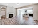 Open-concept living room with fireplace, flowing into the kitchen with an island and modern appliances at 14726 Tamarack Dr, Charlotte, NC 28278