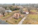 An aerial shot displays a brick home with a long driveway and spacious lot at 1489 Riley St, Albemarle, NC 28001