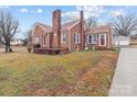 Brick home with a well-maintained lawn, showcasing its architectural design at 1489 Riley St, Albemarle, NC 28001
