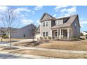 View of the property showcasing the well-maintained lawn and architectural details at 15319 Venezia Ln, Huntersville, NC 28078
