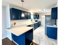 Updated kitchen features modern countertops, stylish blue cabinetry, and stainless steel appliances at 1936 Russell Ave, Charlotte, NC 28216