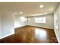 Bright and open living room boasts beautiful hardwood floors and fresh, neutral paint at 1936 Russell Ave, Charlotte, NC 28216