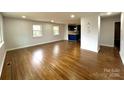 Spacious living room featuring gleaming hardwood floors and abundant natural light at 1936 Russell Ave, Charlotte, NC 28216