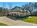 Spacious three-car garage with a large driveway and well-maintained landscaping at 2013 Gladelynn Ct # 354, Belmont, NC 28012