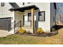 Charming front porch with black railing, a wooden post, and landscaping at 2143 Country Club Rd, Lincolnton, NC 28092