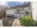 Inviting front entrance with well maintained landscaping and a charming covered porch at 30 Timberidge Dr, Lake Wylie, SC 29710